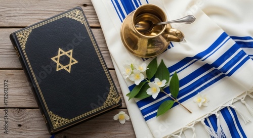 Jewish Symbols Torah with Tallit, Cup  Flowers on Wooden Table, and Symbolizing Faith.
