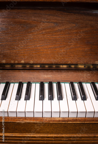 Old piano keys. Close-up of piano keys focused on one note with foreground and background fading into the distance. Musical concept theme