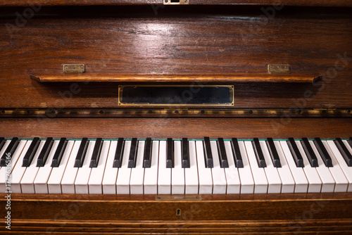 Old piano keys. Close-up of piano keys focused on one note with foreground and background fading into the distance. Musical concept theme