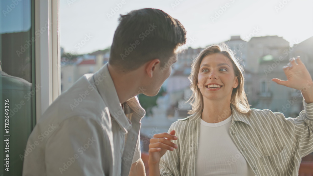 Obraz premium Cheerful girl speaking boyfriend on balcony closeup. Relaxed people enjoying