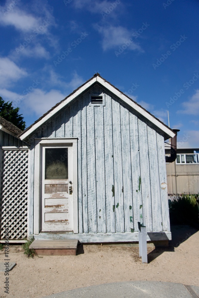 Obraz premium Rustic Coastal Cottage with Teal Window, Monterey California