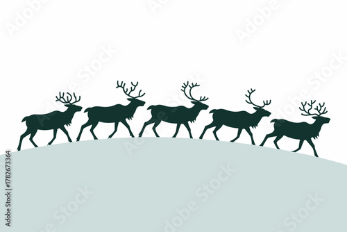 A team of reindeer trot across a snow-covered hill under a clear sky.
