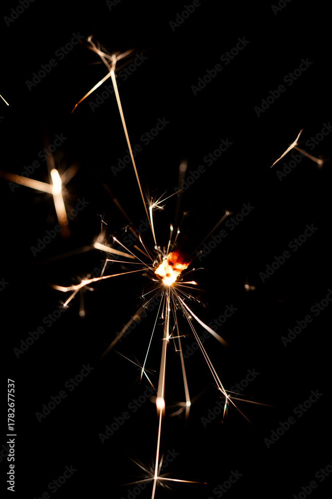 Obraz premium Bright Sparklers Burning on Pure Black Background