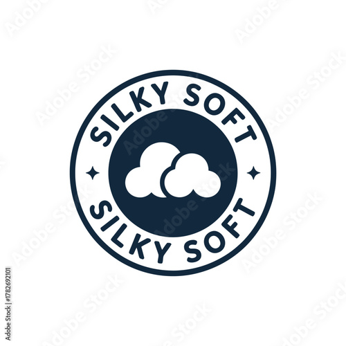 Circular badge with clouds and the words silky soft in navy blue and white