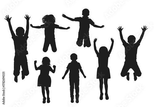 Silhouettes of children jumping and playing with raised arms outdoors