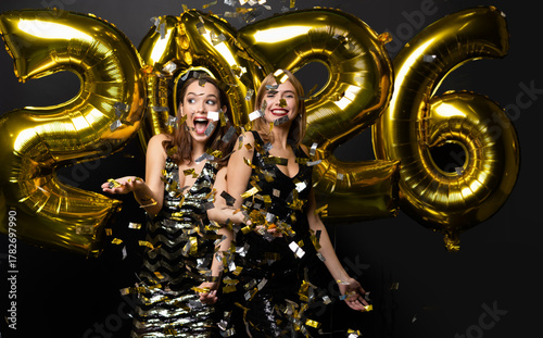 Beautiful Women Celebrating New Year. Happy Girls In Stylish Dresses Holding Gold Balloons, Having Fun At New Year's Eve Party