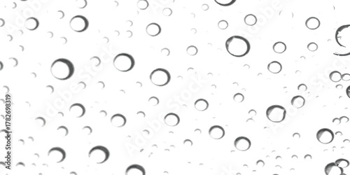 Macro view of clear water droplets and air bubbles on a transparent surface
