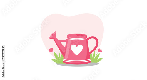 A cute pink watering can with a white heart design sits among green grass and small pink flowers, set against a soft pink heart background.