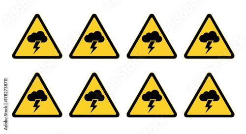 Yellow warning signs depicting a lightning bolt inside a triangle appear