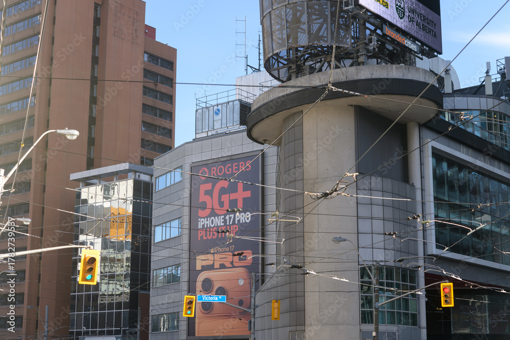 Obraz premium view of property at 33 Dundas St E, edge of Sankofa Square, with Rogers Communications digital ad for iPhone 17 pro, Toronto
