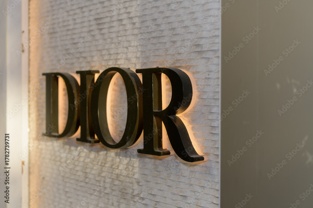 Naklejka premium close-up of sign outside DIOR, a clothing store, located at 131 Bloor St W, Floor 1 of The Colonnade, Toronto