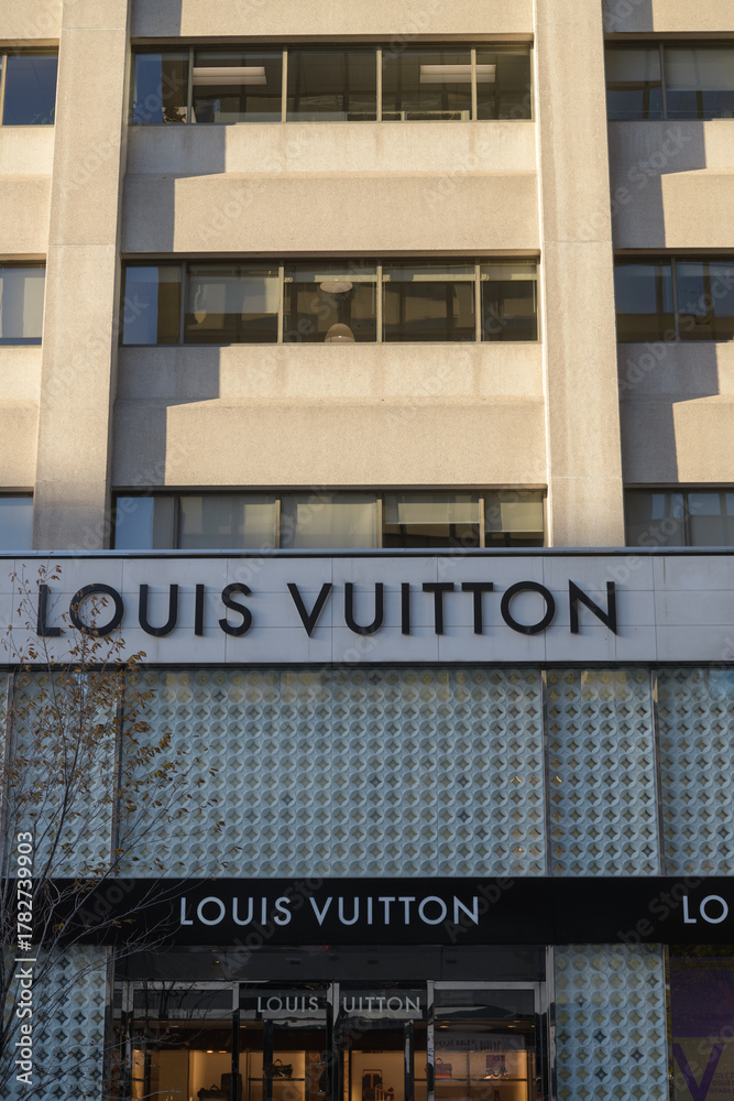 Obraz premium exterior building facade entrance and signs outside Louis Vuitton, a leather goods store, located at 150 Bloor St W, Toronto
