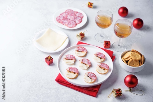 Salami sausage and cheese slices and crackers in the form of Santa Claus for Christmas holidays