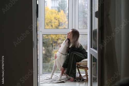 beautiful woman with very nice and smart dog at home