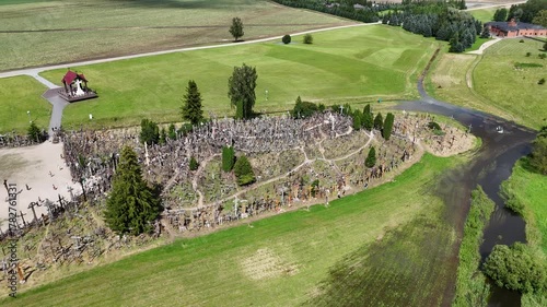 Hill of Crosses, Siauliai, Lithuania — August 1, 2025: Panoramic aerial footage captured by drone. The scene shows thousands of wooden and metal crosses, walking paths and the surrounding countryside 