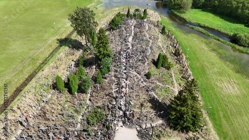 Hill of Crosses, Siauliai, Lithuania — August 1, 2025: Panoramic aerial footage captured by drone. The scene shows thousands of wooden and metal crosses, walking paths and the surrounding countryside 