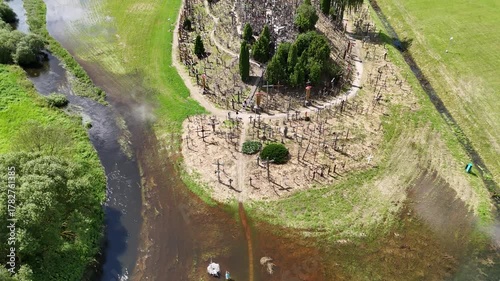 Hill of Crosses, Siauliai, Lithuania — August 1, 2025: Panoramic aerial footage captured by drone. The scene shows thousands of wooden and metal crosses, walking paths and the surrounding countryside 