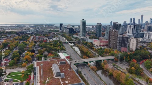 Beautiful drone view of the Don Valley Parkway, Riverdale Park, the Don River and the downtown Toronto skyline looking southwest in autumn, Ontario, Canada. Toronto architecture and skyscrapers.