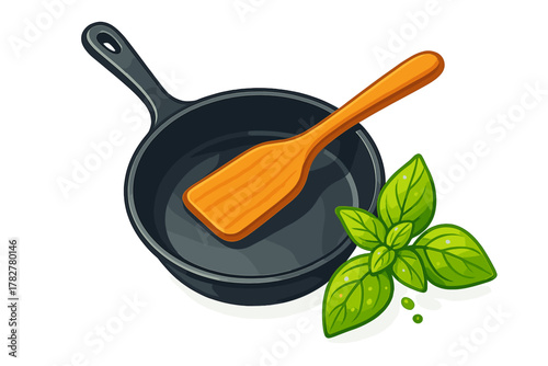 Cast iron frying pan with wooden spatula and fresh basil leaves cooking ingredients