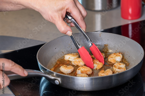 A close up look of prawns sizzling in a frying pan.