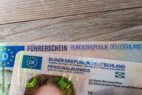 Fotografi German ID card and driver’s license in hand, EU flag, Modern European driving pe
