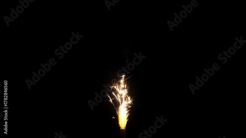 Bengal candle sparkler burning on black background. Fountain cake firework sparkling in the dark. Closeup
