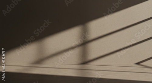 Sunlight streams diagonally casting bold shadows on a textured beige interior wall