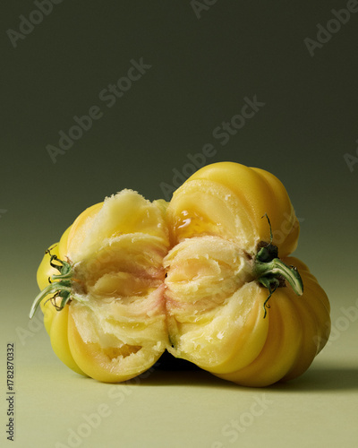 Yellow Heirloom Torn Tomatoes Painterly Still Life on Green Seamless background. Film grain