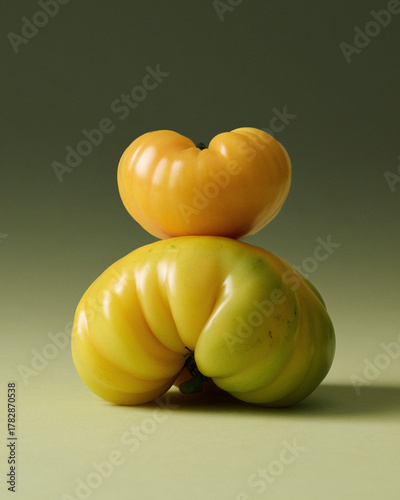 Yellow Heirloom Tomatoes Stacked Painterly Still Life on Green Seamless background. Film grain