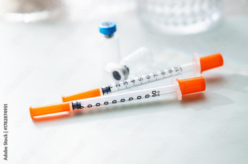 Naklejka premium Close up of Single Use Syringes with Small Glass Vials
