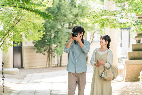 A man and woman taking photos with a single-lens reflex camera on a trip
