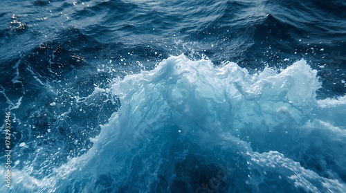 Fototapeta Naklejka Na Ścianę i Meble -  Waves crashing in the ocean on a sunny day with blue water surface