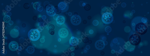 Abstract blue winter background with glowing snowflake bokeh lights and blurred festive elements