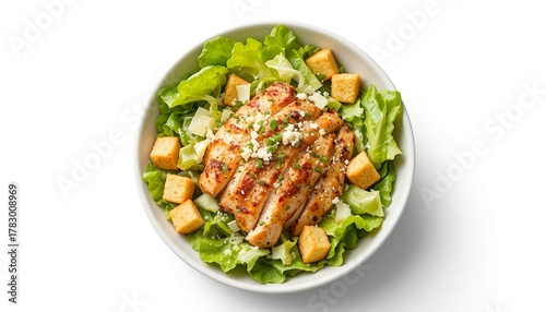 Bowl of Caesar salad with lettuce, croutons, grilled chicken, and parmesan cheese, isolated on white background