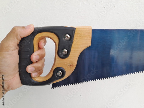 Close-up Asian man holding a saw with a black handle isolated on white background