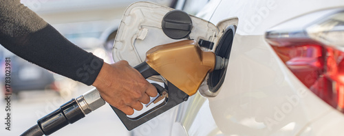 Man Refill and filling Oil Gas Fuel at station. Gas station - refueling.