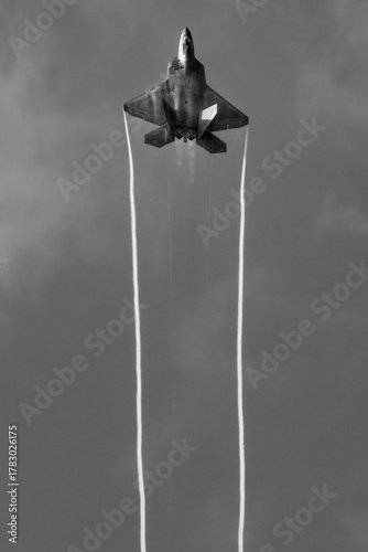 Modern military jet flying in black and white
