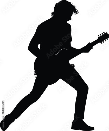 Silhouette of a male rock guitarist performing with an electric guitar in an energetic stance