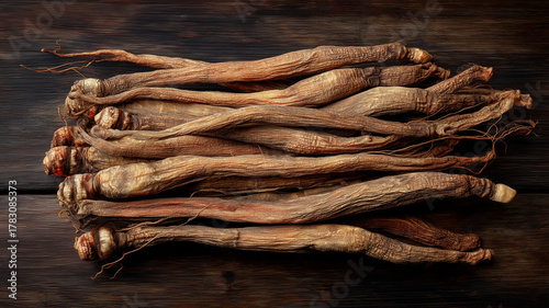 Dried Korean red ginseng roots arranged neatly on wooden surface, showcasing their unique texture and color. This natural herbal product is known for its health benefits and traditional uses