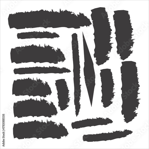 This image displays a collection of dark gray brush strokes against a white background. The strokes vary in length, thickness, and orientation, creating a dynamic and abstract composition. Some appear