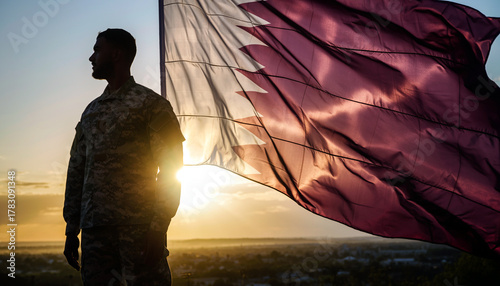 Powerful soldier silhouette stands with Qatar flag at sunset, embodying patriotism and national pride for remembrance day events and independence celebrations