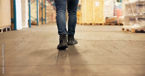 Photos Person, legs and walking with boxes in warehouse for inventory, storage maintenance or stock
