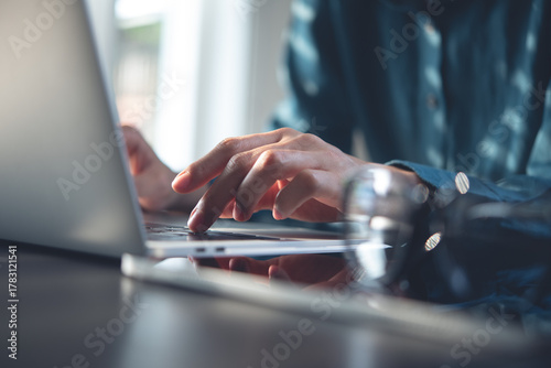 Photography Close up, business woman hand typing, working on laptop computer on table office with sunlight