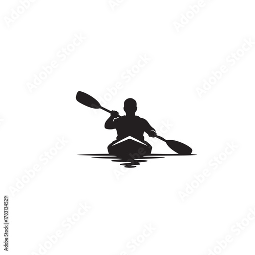 Silhouette of a kayaker paddling on a calm lake at dawn.