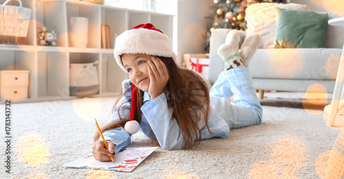 Little girl in Santa hat wr...