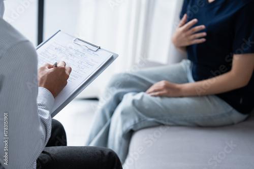 sad female sitting on sofa Patient discussing mental health issues with psychologist. depressed asian woman mental health treatment