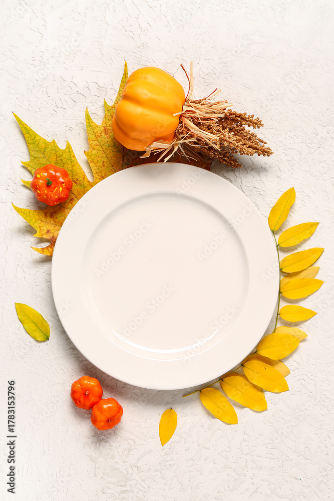 Fototapeta premium Stylish autumn table setting with pumpkins and leaves on white background