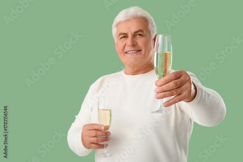 Happy senior man with glass...