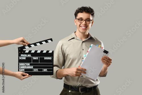 Male screenwriter holding s...