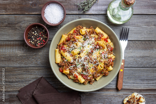 Pasta with bolognese sauce and cheese. Italian cuisine. Traditional recipe.